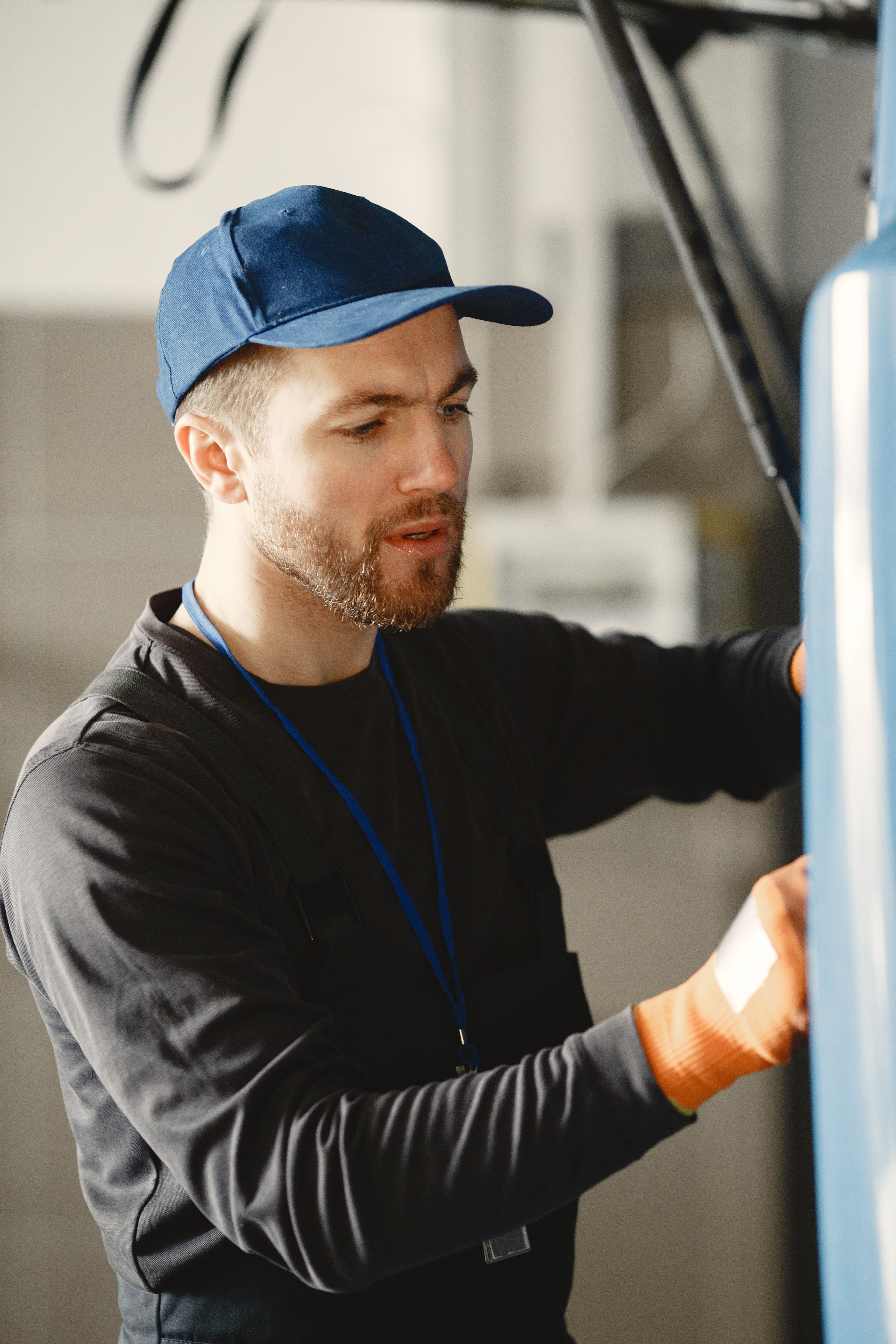 Friendly Furnace technician working on equipment inside a residential home.