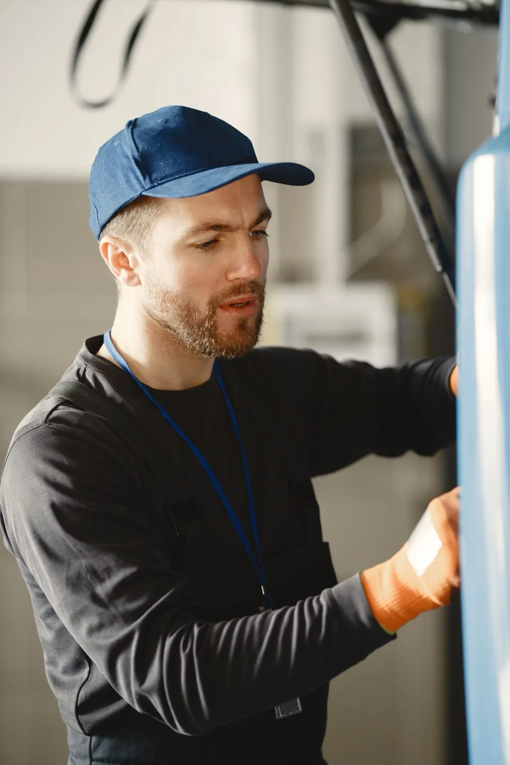 Friendly Furnace technician working on equipment inside a residential home.